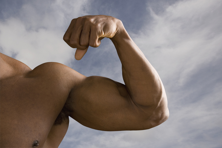 Close up of man's flexed biceps