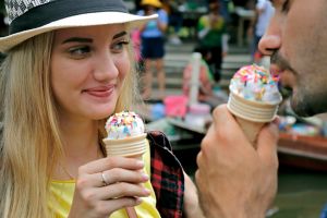 Happy couple having date and eating ice cream cone