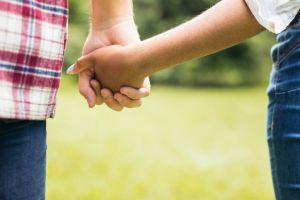 Interracial couple taking a walk hand in hand in the park