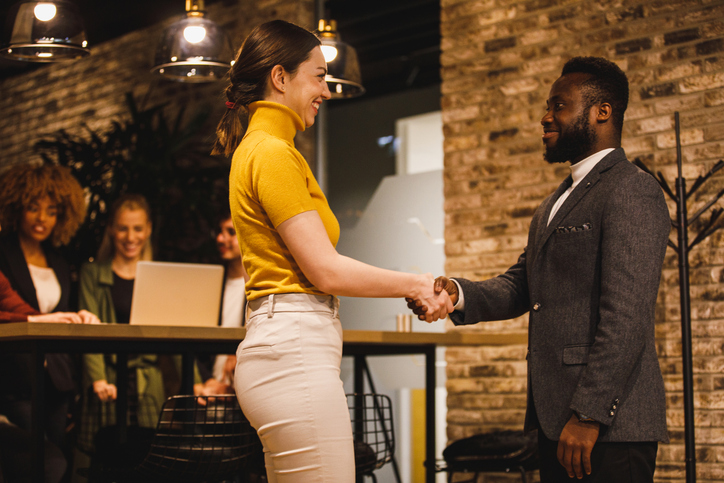 Two business persons shaking hands, new business agreement