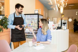 Shot of a young woman making a card payment using a nfc machine