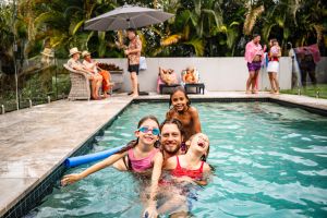 Candid portrait of man with children at pool party