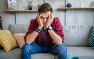 Young worried man at home